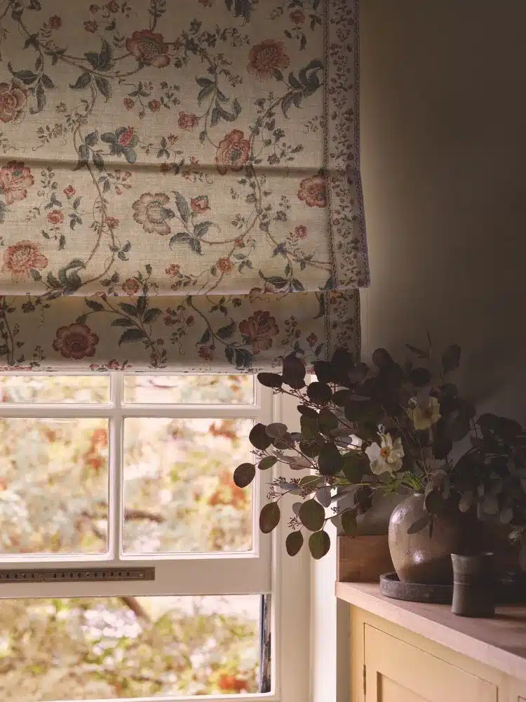Floral Roman blinds in a classic kitchen with flower vase