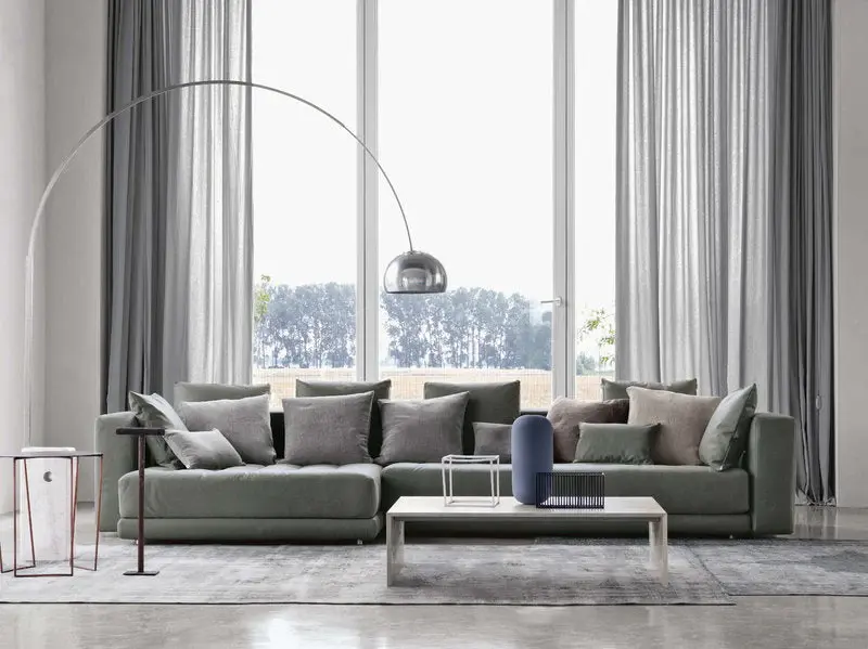 Flos Arch in living room environment with gray sofa and modern ambiance